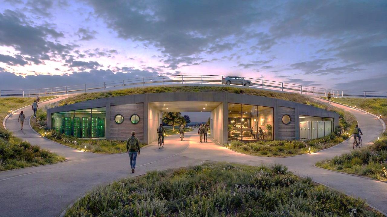 Render of a crossing at dusk, with a car passing over a glazed building that people walk and cycle through